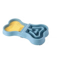 Gamelle anti-glouton en forme d'os avec tapis à lécher, coloris bleu avec tapis jaune, vue de dessus sur fond blanc