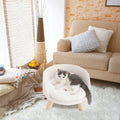 Lit surélevé BINGOPAW rond en peluche blanche à dossier haut sur pieds en bois, chat gris et blanc dedans