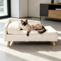 Canapé surélevé en peluche BINGOPAW blanc crème avec un chat siamois allongé, pieds en bois naturel